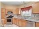 Bright kitchen features stainless steel appliances, granite countertops, and light-colored cabinets at 5043 Mascaro Dr, Las Vegas, NV 89122