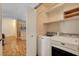 Convenient laundry room features Maytag washer/dryer, shelving, and a view of the kitchen at 5043 Mascaro Dr, Las Vegas, NV 89122