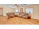 Spacious living room with wood-look floors, a large sectional sofa, and windows for natural light at 5043 Mascaro Dr, Las Vegas, NV 89122