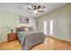 Tranquil main bedroom with french doors, ceiling fan, and decorative bedside table at 5043 Mascaro Dr, Las Vegas, NV 89122