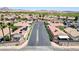 An aerial view of a quiet community street with green desert landscaping at 5043 Mascaro Dr, Las Vegas, NV 89122