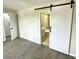 En suite bathroom features a sliding barn door entry, tile flooring and walk-in shower at 5191 Caliente St # 84, Las Vegas, NV 89119