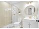 A stylish bathroom showcasing a glass enclosed shower, white vanity, gold fixtures, and floating shelves at 5191 Caliente St # 84, Las Vegas, NV 89119