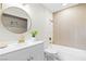 Renovated bathroom featuring a stylish vanity with a modern gold faucet and a shower-tub combo at 5191 Caliente St # 84, Las Vegas, NV 89119