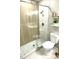 Updated bathroom with glass shower, white vanity with gold fixtures and decorative shelving at 5191 Caliente St # 84, Las Vegas, NV 89119