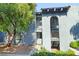 Condo exterior with lush landscaping, mature trees, and well-maintained pathways at 5191 Caliente St # 84, Las Vegas, NV 89119