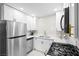 Modern kitchen with stainless steel appliances, white cabinets, quartz countertops and gas range at 5191 Caliente St # 84, Las Vegas, NV 89119