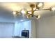 Modern light fixture over the kitchen with the white kitchen cabinets in the background at 5191 Caliente St # 84, Las Vegas, NV 89119
