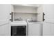 Updated laundry area with white washer and dryer inside of a closet space with double doors at 5191 Caliente St # 84, Las Vegas, NV 89119