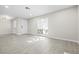 Bright living room with light gray wood floors, recessed lights and ample natural light from the front window at 5191 Caliente St # 84, Las Vegas, NV 89119