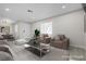 Bright living room featuring modern furniture, including armchairs, sofa, ottoman and a dining area nearby at 5191 Caliente St # 84, Las Vegas, NV 89119