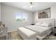 Staged main bedroom featuring a sleek white headboard and a large window with bright natural light at 5191 Caliente St # 84, Las Vegas, NV 89119