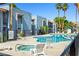 Community pool with ample seating and palm trees, perfect for relaxation at 5191 Caliente St # 84, Las Vegas, NV 89119