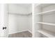 A walk-in closet featuring painted white walls, wood-look floors and multiple shelving units at 5191 Caliente St # 84, Las Vegas, NV 89119