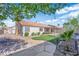 Well-maintained backyard featuring mature landscaping, a small lawn, and a stepping stone pathway at 5437 Escallonia St, Las Vegas, NV 89149