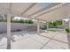 Spacious backyard featuring a covered patio with a built-in BBQ and a manicured lawn at 5437 Escallonia St, Las Vegas, NV 89149