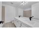 A well lit primary bathroom featuring a double vanity with square sinks and tile flooring at 5437 Escallonia St, Las Vegas, NV 89149