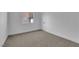Bedroom with neutral carpet, white walls, window and a door at 5437 Escallonia St, Las Vegas, NV 89149