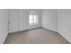 Carpeted bedroom with a double sliding door closet, window, and light gray walls at 5437 Escallonia St, Las Vegas, NV 89149