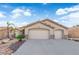 Inviting single-story home with a dual-car garage, desert landscaping, and warm neutral tones at 5437 Escallonia St, Las Vegas, NV 89149