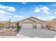 Charming single-story home featuring a two-car garage, desert landscaping, and a tile roof at 5437 Escallonia St, Las Vegas, NV 89149