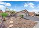 Single-story home with low-maintenance desert landscaping, attached garage, and a pathway to the entrance at 5437 Escallonia St, Las Vegas, NV 89149