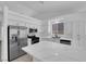 Bright kitchen featuring stainless steel appliances, a large island, and crisp white cabinets at 5437 Escallonia St, Las Vegas, NV 89149