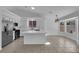 Well-lit kitchen with stainless appliances, a central island, ample cabinet space and adjacent eat-in area at 5437 Escallonia St, Las Vegas, NV 89149