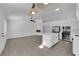 Open-concept kitchen and living space featuring white cabinets and a modern fireplace at 5437 Escallonia St, Las Vegas, NV 89149