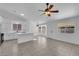 Bright kitchen and dining area with white cabinets, tile flooring, and a ceiling fan at 5437 Escallonia St, Las Vegas, NV 89149