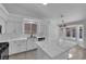 White kitchen with stainless steel appliances, large island, and a breakfast nook with lots of light at 5437 Escallonia St, Las Vegas, NV 89149