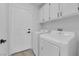 Clean, well-lit laundry room featuring modern appliances and crisp white walls and trim at 5437 Escallonia St, Las Vegas, NV 89149
