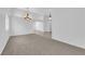 Spacious living area with carpet, featuring a chandelier and arched entryway at 5437 Escallonia St, Las Vegas, NV 89149