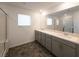 Bathroom with double sink vanity, quartz countertops, tile floor, and glass-enclosed shower at 5904 Becklow Gardens Ave, Las Vegas, NV 89141