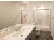 Modern bathroom with a white vanity, a glass-enclosed shower, and stylish tile flooring at 5904 Becklow Gardens Ave, Las Vegas, NV 89141