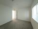 Bright bedroom with plush carpeting, a window, and an open doorway at 5904 Becklow Gardens Ave, Las Vegas, NV 89141