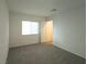 Well lit bedroom featuring plush carpeting and a window at 5904 Becklow Gardens Ave, Las Vegas, NV 89141