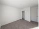 Bedroom featuring plush carpeting, closet, and an entrance door at 5904 Becklow Gardens Ave, Las Vegas, NV 89141