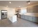 Modern kitchen with stainless steel appliances, center island, and sleek gray cabinets at 5904 Becklow Gardens Ave, Las Vegas, NV 89141
