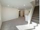 Bright living room featuring neutral walls, carpeted floors, and a staircase to the right at 5904 Becklow Gardens Ave, Las Vegas, NV 89141