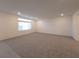 Large, inviting living room with neutral carpet, recessed lighting, and ample natural light at 5904 Becklow Gardens Ave, Las Vegas, NV 89141