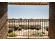 Balcony view with black metal railing overlooking the street with residential buildings and greenery at 595 Sellers Pl, Henderson, NV 89011