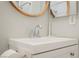 Close-up of a bathroom sink with a white vanity, chrome faucet, and an electric toothbrush on the counter at 595 Sellers Pl, Henderson, NV 89011