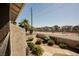 Neighborhood street with landscaped yards, palm trees, and sidewalks as viewed from a condo balcony at 595 Sellers Pl, Henderson, NV 89011