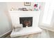Close-up of the painted brick fireplace, decorated with plants and collectibles at 595 Sellers Pl, Henderson, NV 89011