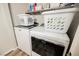 Bright laundry room features modern washer and dryer with white storage baskets at 595 Sellers Pl, Henderson, NV 89011