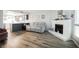 Open-concept living room with wood-look floors, seamlessly flowing into the kitchen area at 595 Sellers Pl, Henderson, NV 89011
