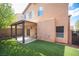 This property features a well-maintained backyard with a covered patio and lush artificial grass at 6029 Allanche Ave, Las Vegas, NV 89141