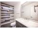 Stylish bathroom with a marble countertop vanity, modern fixtures, and a horizontally paneled accent wall at 6029 Allanche Ave, Las Vegas, NV 89141