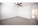 Spacious carpeted bedroom with neutral walls and ceilings, and a ceiling fan at 6029 Allanche Ave, Las Vegas, NV 89141